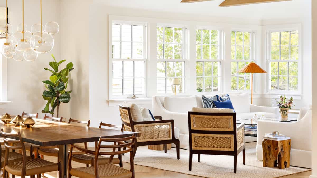 Open plan living dining room with cane chairs, designed by Charlotte Save