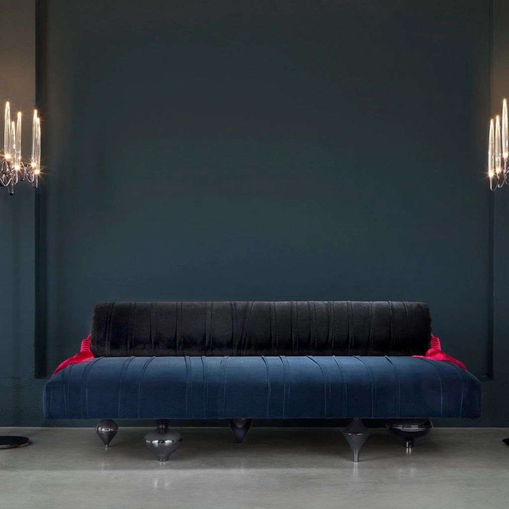 Il Pezzo Mancante velvet sofa paired with stunning contemporary lighting.
