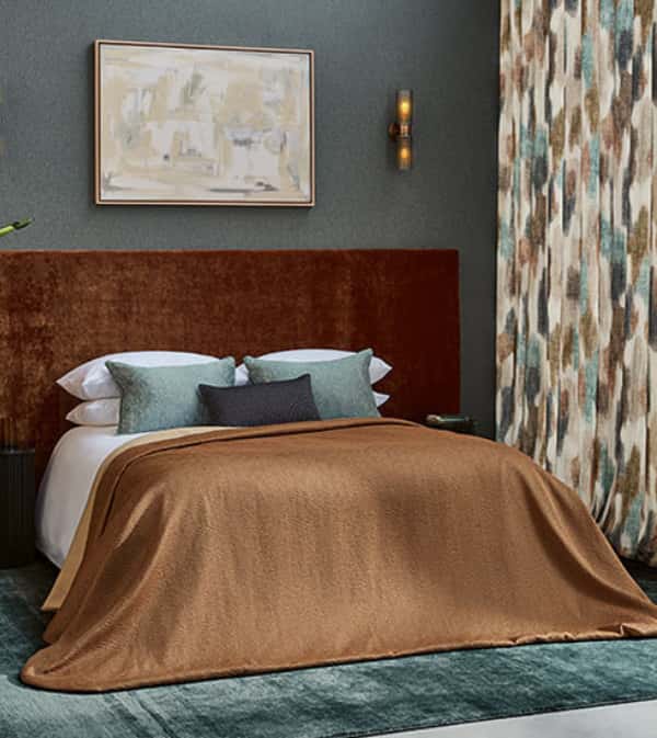 Luxury bedroom featuring Villanova bedding and curtain designs.