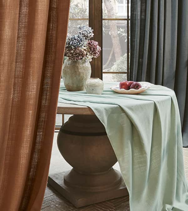 Stylish dining setting with Villanova table and flowers.