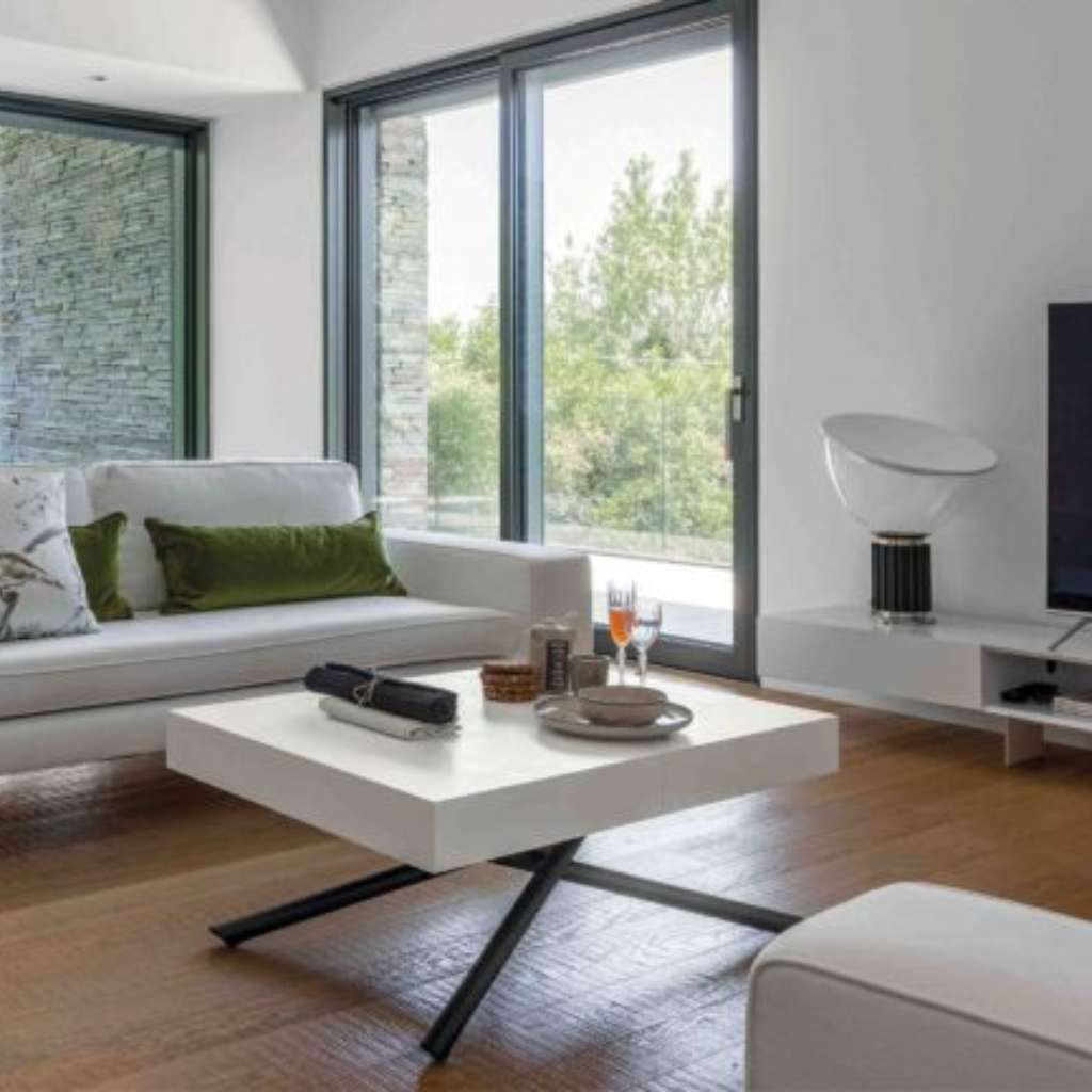 Altacom minimalist white living room with contemporary coffee table.