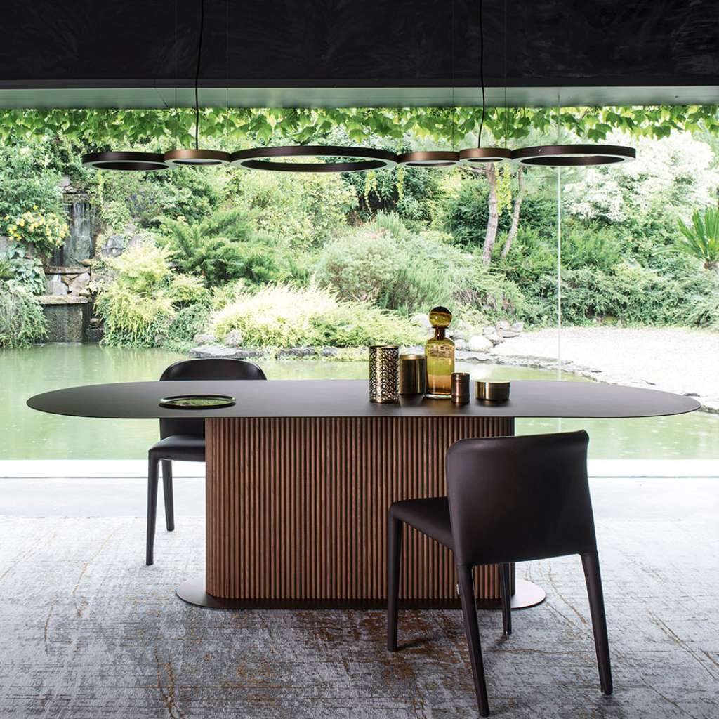 Alf DaFre ribbed wood dining set with oval table, sideboard and slim chairs, garden view.