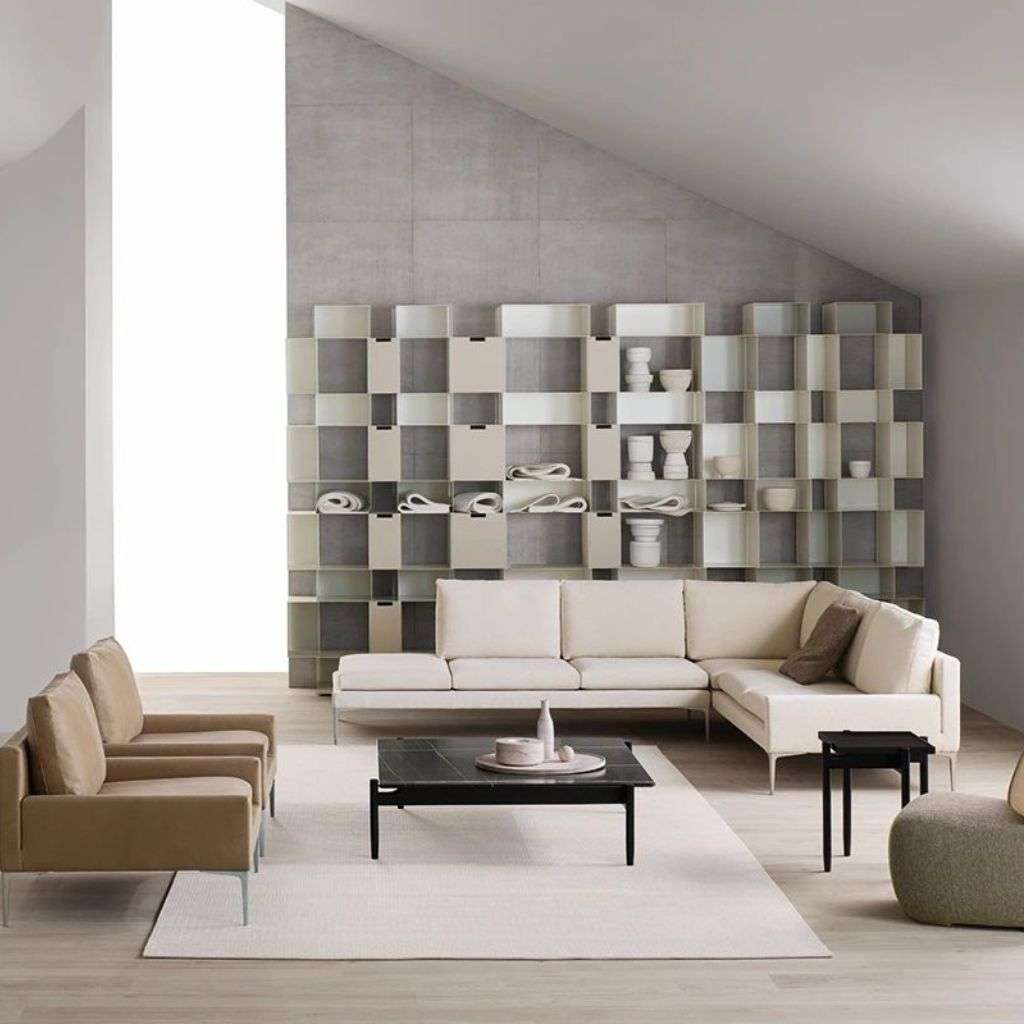 Amura beige sectional sofa with modern shelving units in the background.