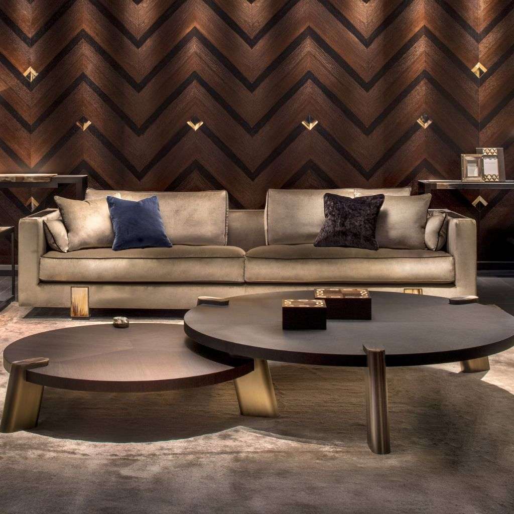 arcahorn beige sofa with round coffee tables and chevron wood wall