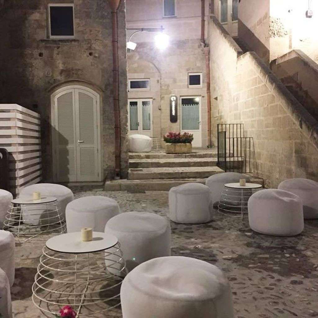 Charming outdoor lounge with white and copper seating designed by Barel.