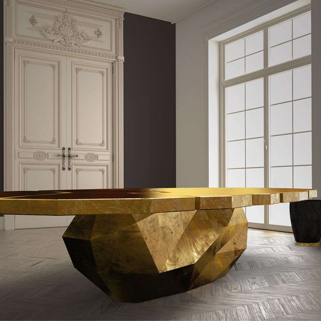 Golden Bateye dining table with bold sculptural base in luxury room.