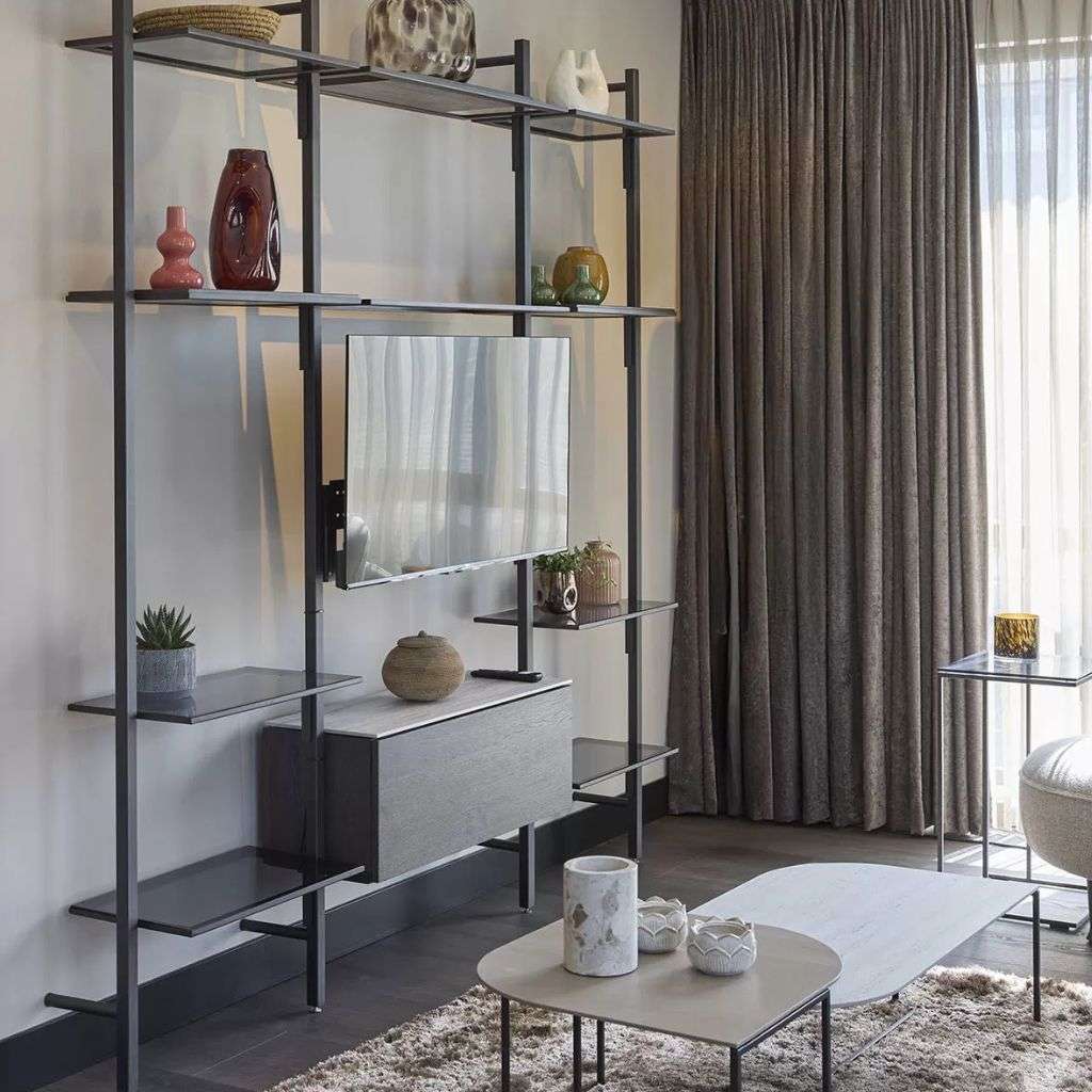 Bert Plantagie shelves with modern decor, including vases and a TV unit.