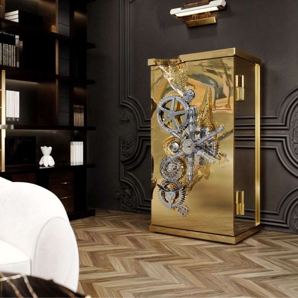Boca do Lobo gilded artistic safe with intricate gear design in a stylish room.