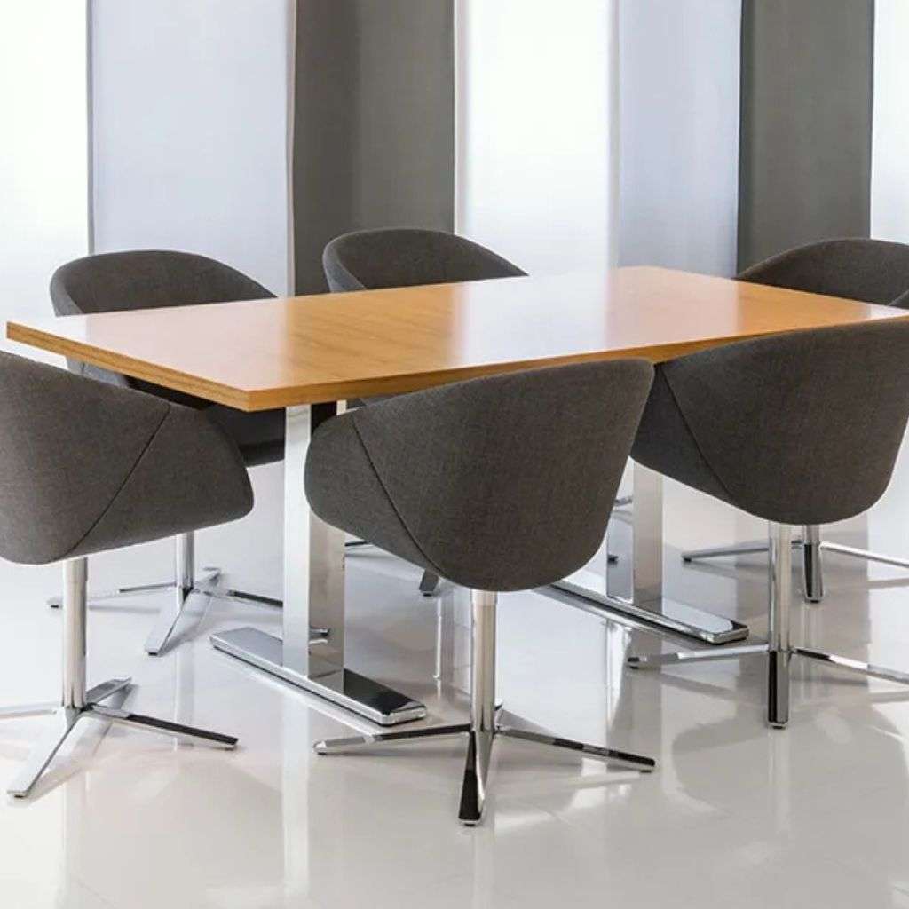 Brune luxury dining chairs surrounding a wooden table.