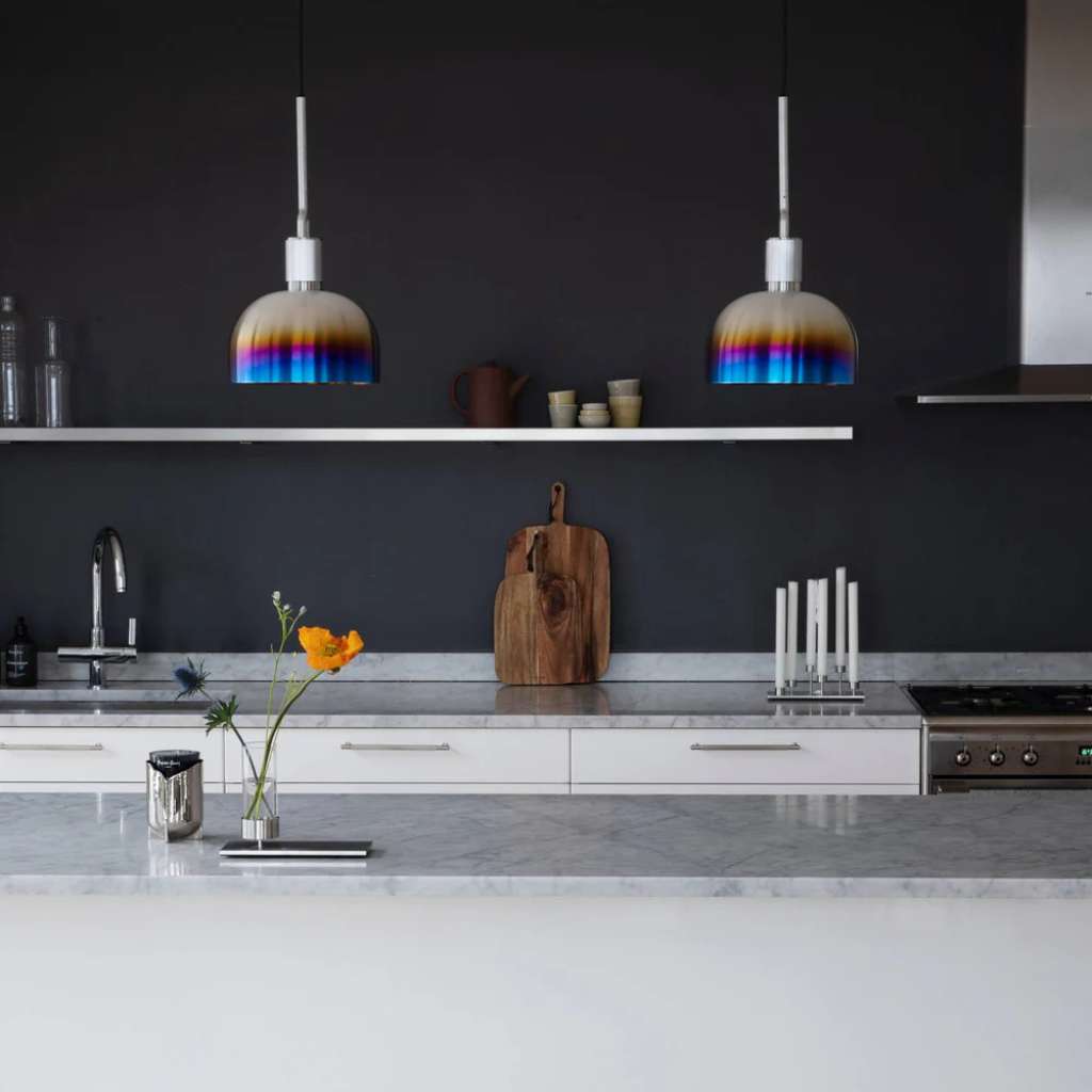 Buster and Punch rainbow gradient pendant lights hanging over a kitchen counter.