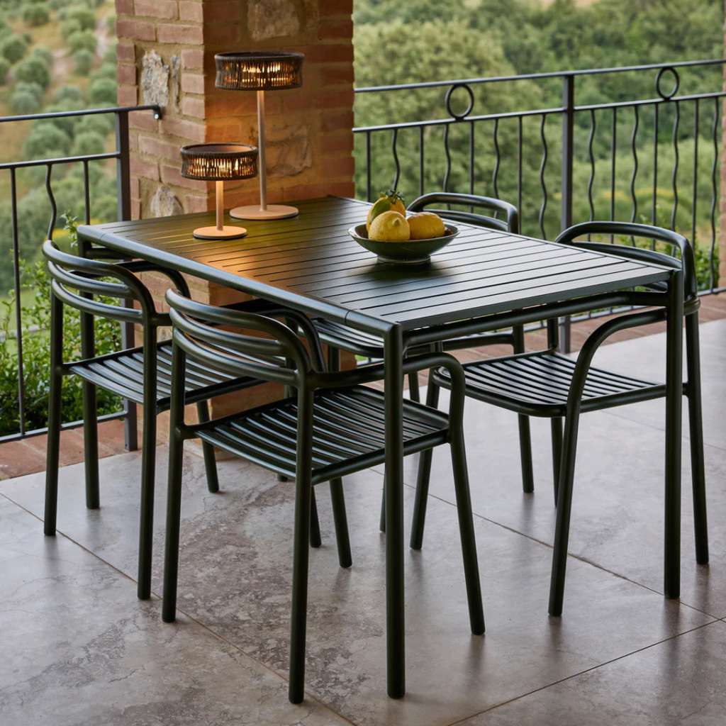 Cane-line dining set with slatted chairs on patio.