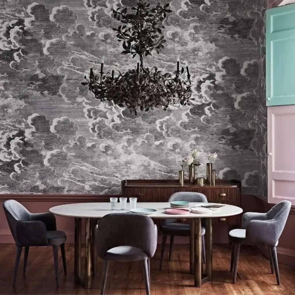 Dramatic cloud-patterned wallpaper in a dining room setting by Cole and Son.