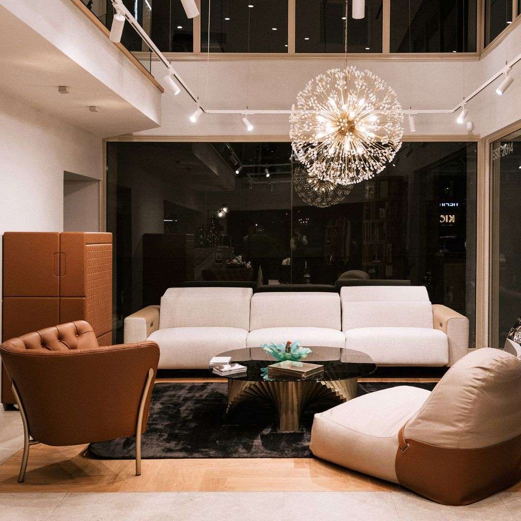 Luxurious living room with beige seating and statement lighting from Collection Alexandra.