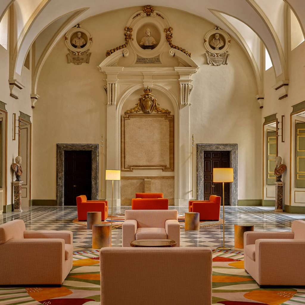 Dedar luxury furniture in a grand room with a stylish geometric rug.