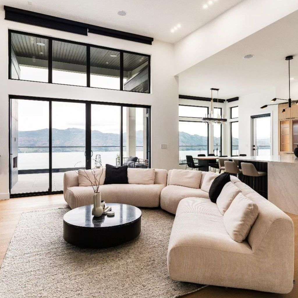 DK Modern's modern curved sofa in a light neutral tone, perfectly blending luxury and comfort in an open-concept living space.