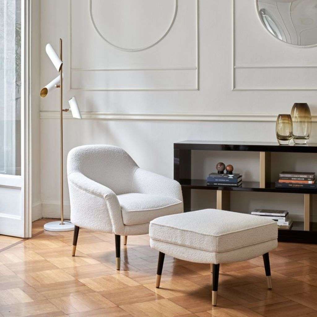 Minimalist armchair and ottoman by Dom Edizioni in chic setting.