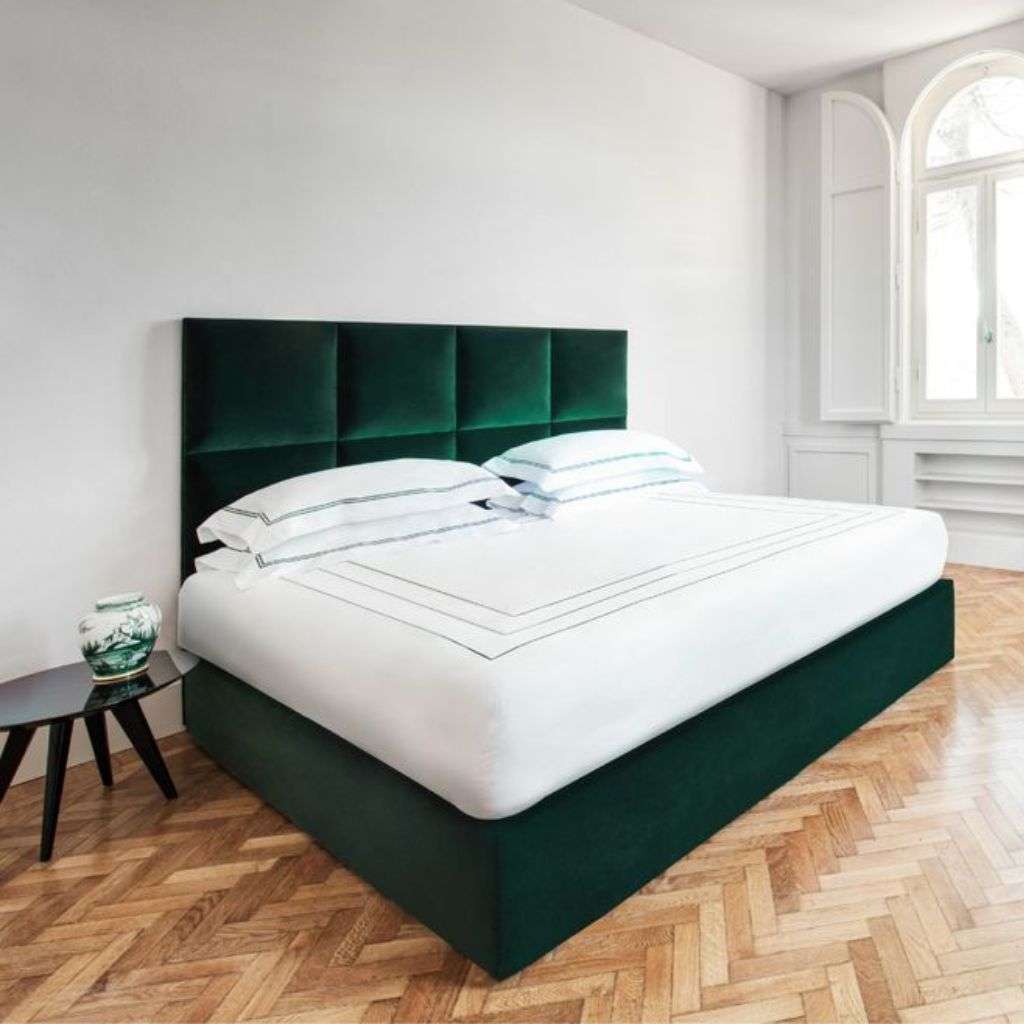 Luxurious bedroom featuring velvet green furniture from Dom Edizioni.