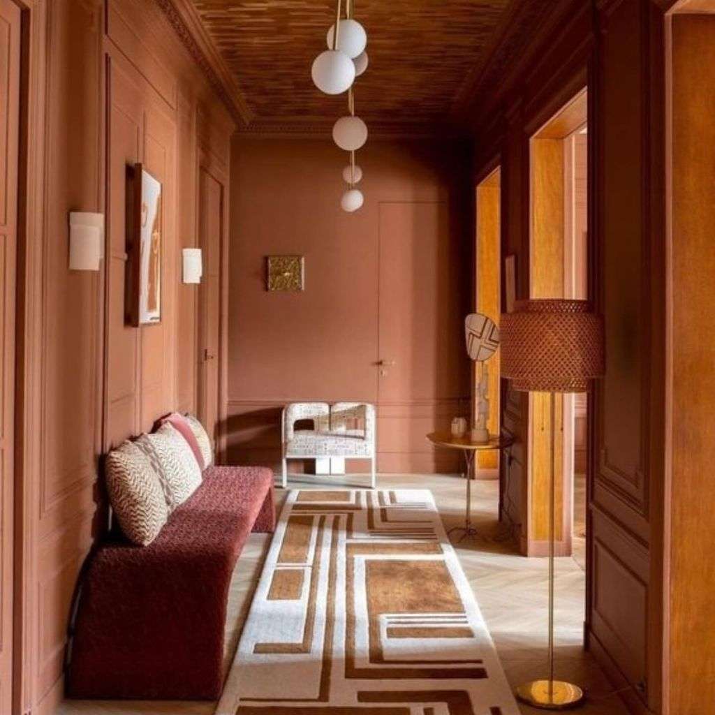 Duquesa & Malvada terracotta hallway with geometric runner rug and burgundy bench