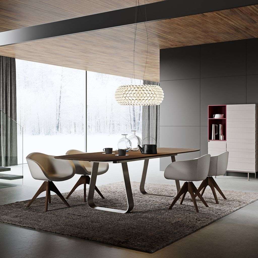 Emmebi walnut dining table with grey chairs and sculptural pendant in a modern room.