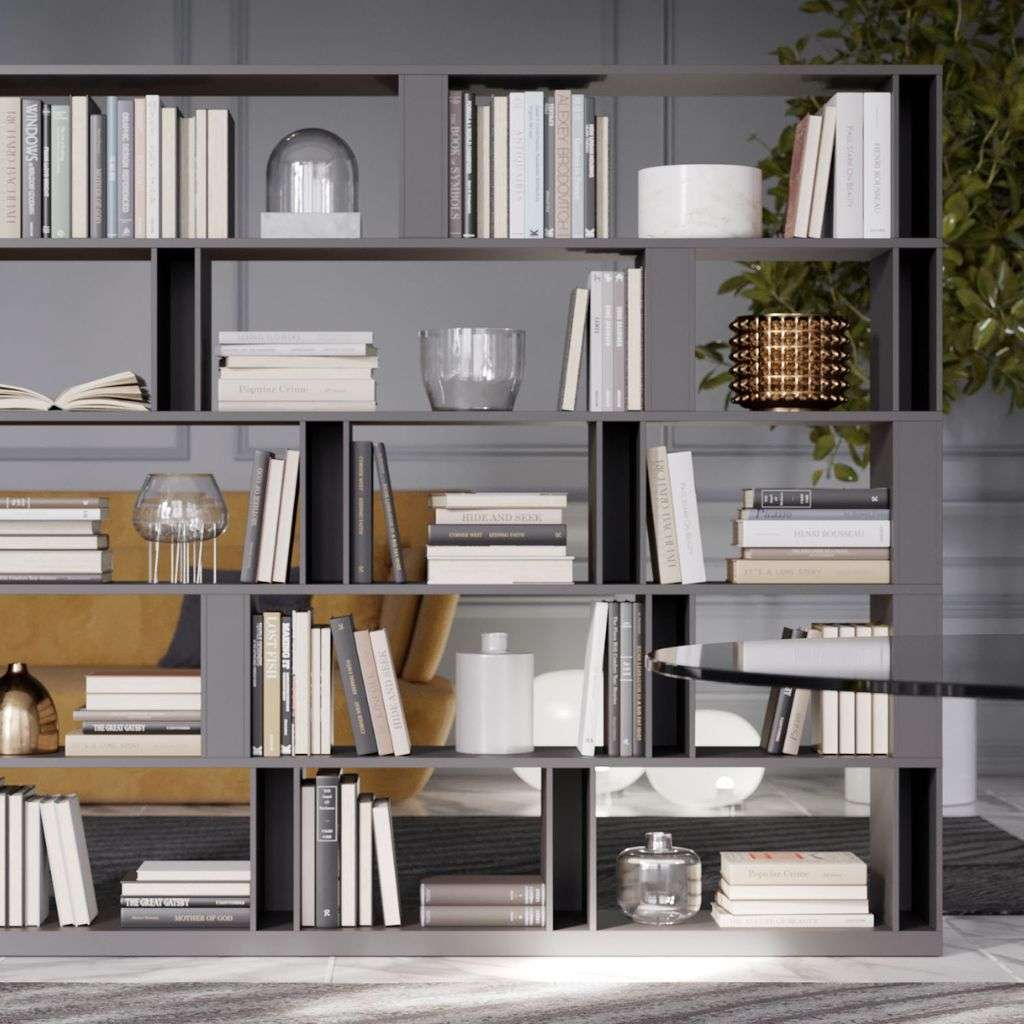 Emmebi modular bookcase in matte grey, used as a room divider with curated decor.
