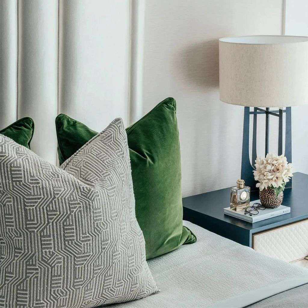 Evitavonni green velvet cushions paired with patterned accents.