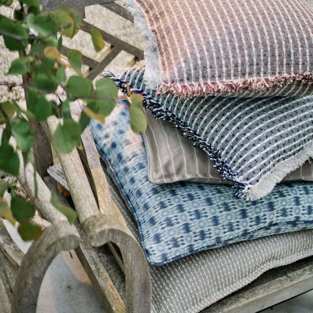 Evitavonni cushions and throws styled on a luxurious sofa.