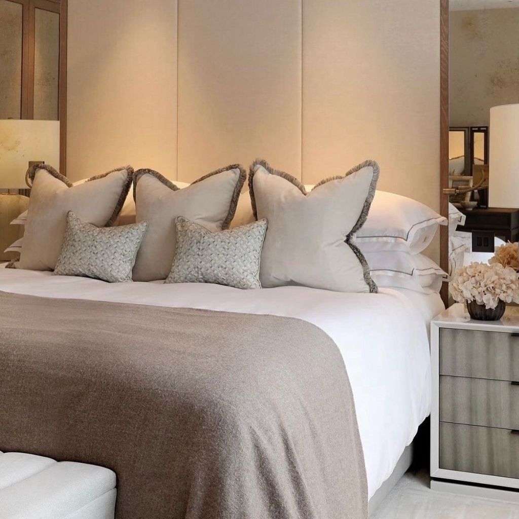 Evitavonni elegant bed design with luxurious cushions and neutral throws.