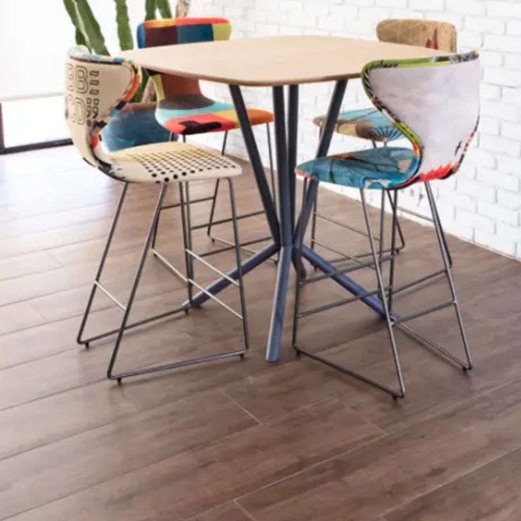 Eclectic, multicolored chairs around a stylish table from Fama's collection.