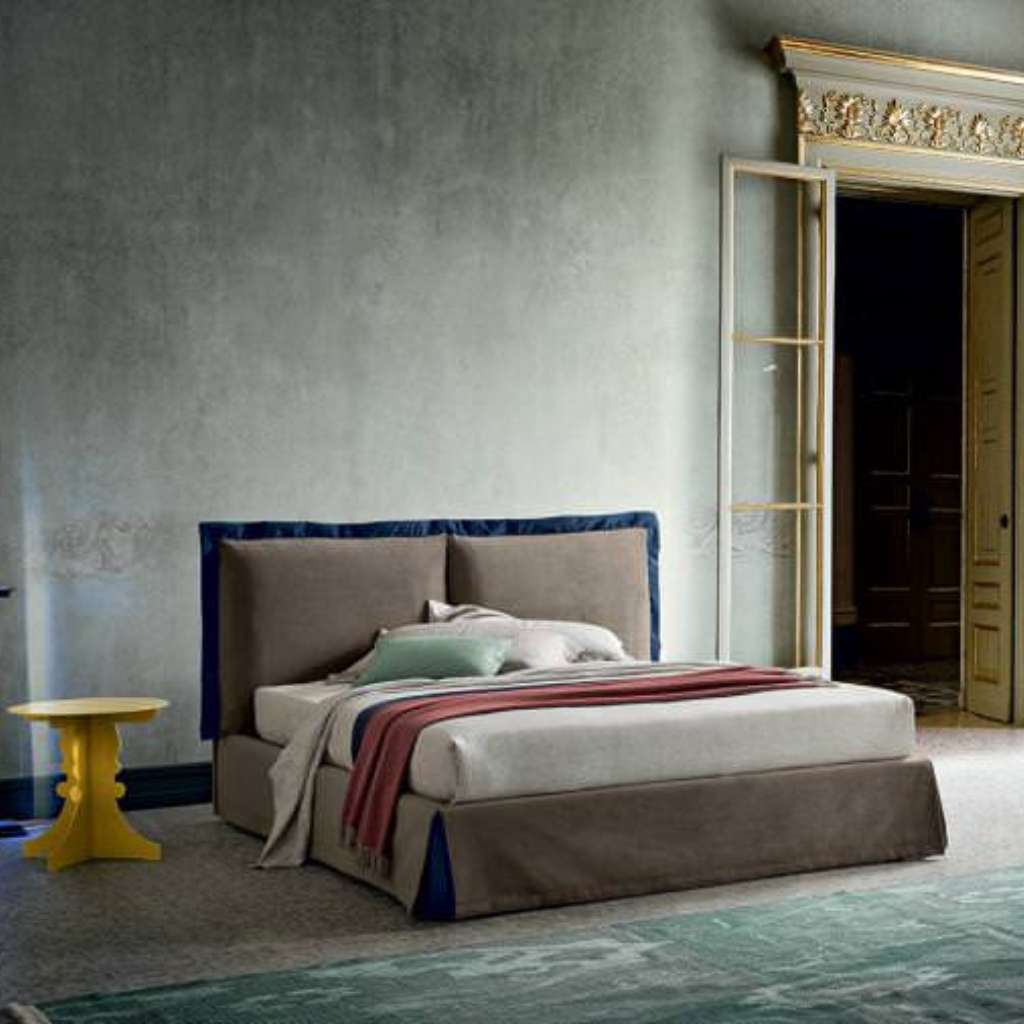 Felix modern bedroom featuring a stylish bed with colorful cushions and minimalist design.