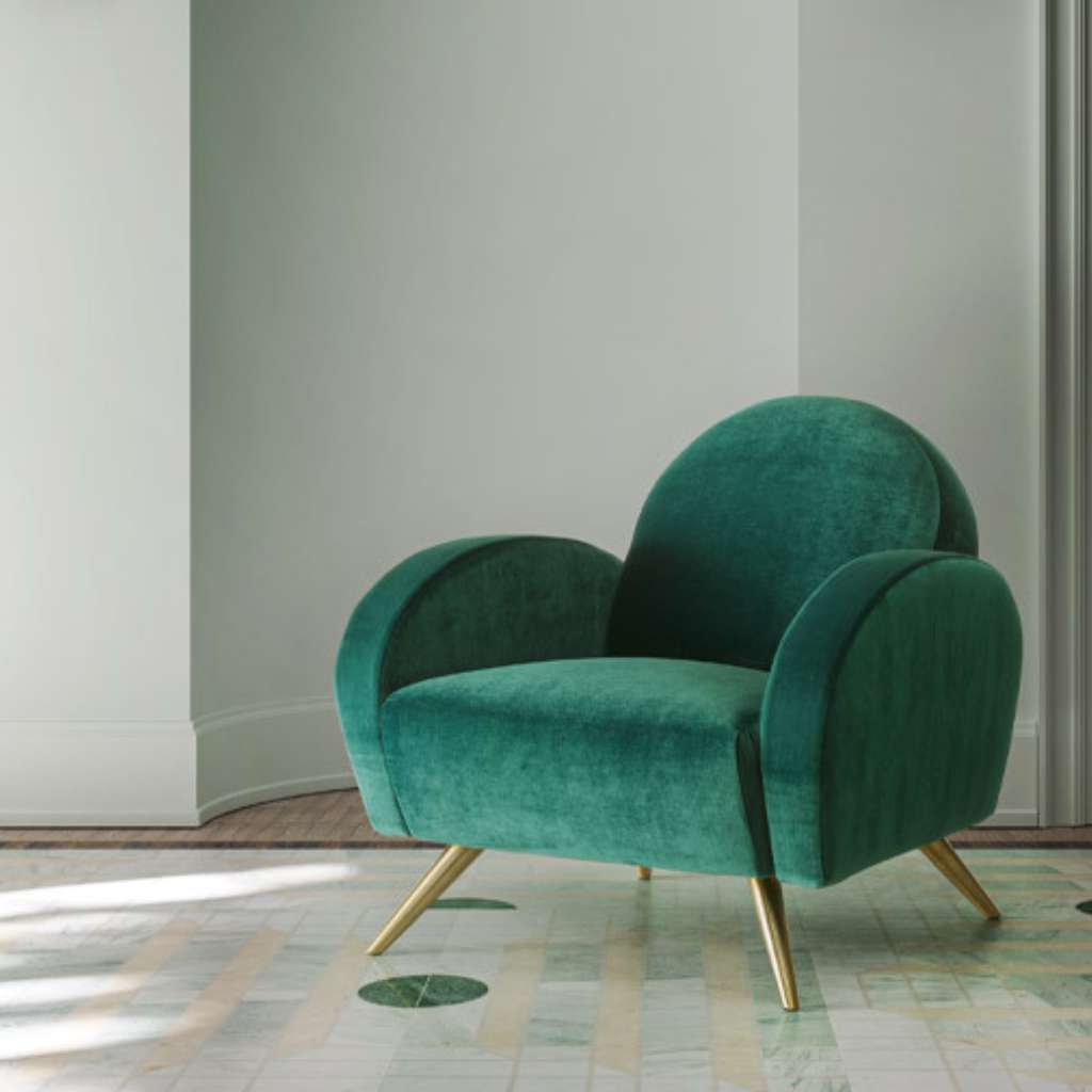 Felix luxurious green velvet armchair with sleek gold legs in a modern living space.