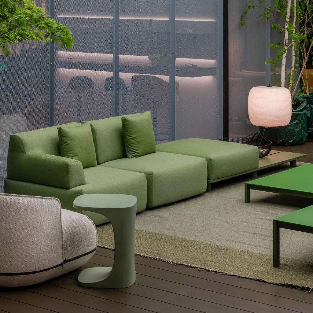 Kristalia modern green sofa in an inviting living space with soft lighting.