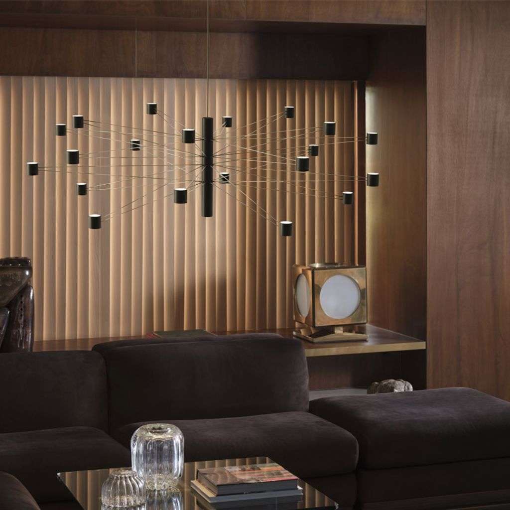 KDLN multi-pendant chandelier with black cylinders over a modern lounge.