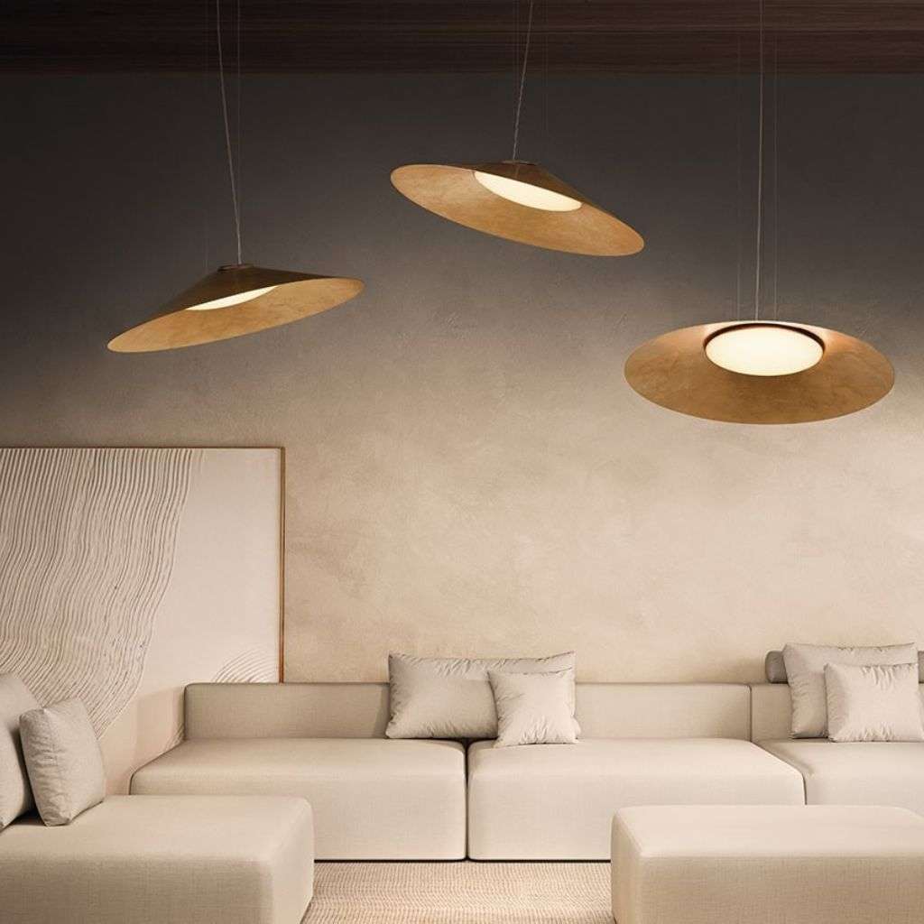sculptural saucer pendants above neutral modular sofas.
