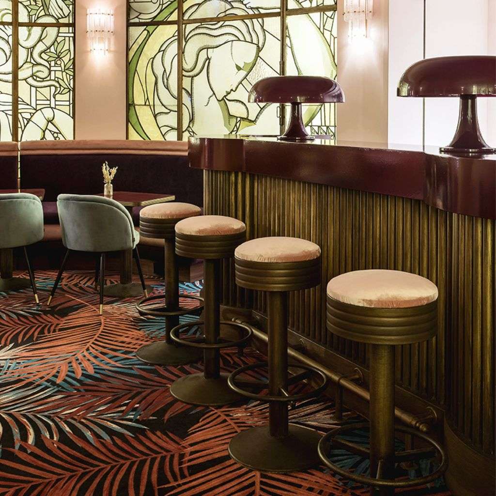 La Fibule bar area with art deco design and lush floral accents.
