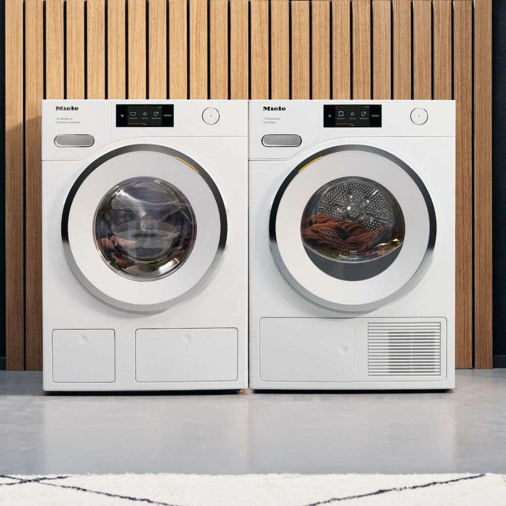 Miele washing machine and heat-pump dryer in a modern utility setting.