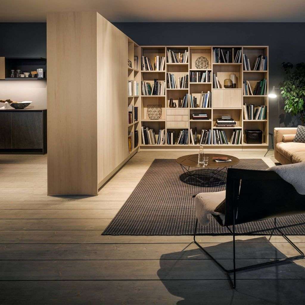 miinu graphite flatweave rug defining a refined library with oak shelving and lounge chair