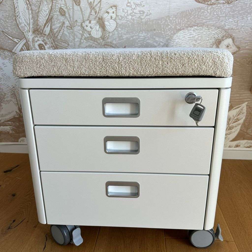 Stylish mobile filing cabinet with cushioned seat by Moll.