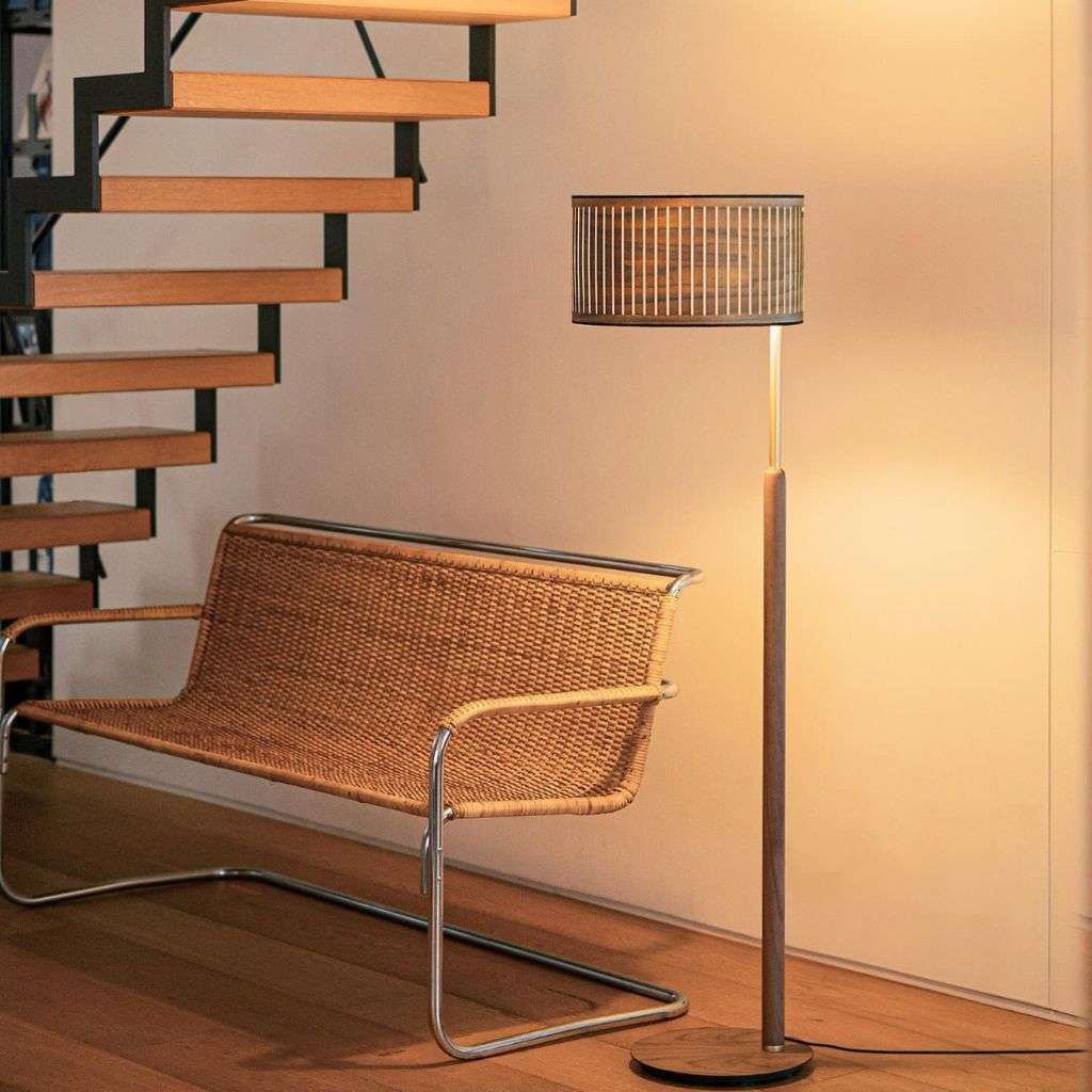 Nomon floor lamp paired with sleek contemporary furniture, offering refined lighting.