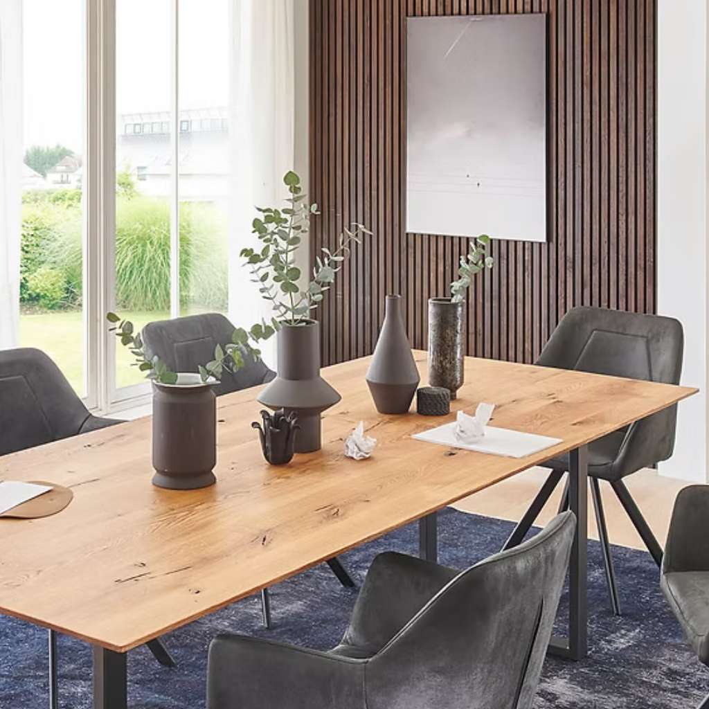 Nou modern dining table with black chairs and sleek wooden accent wall.