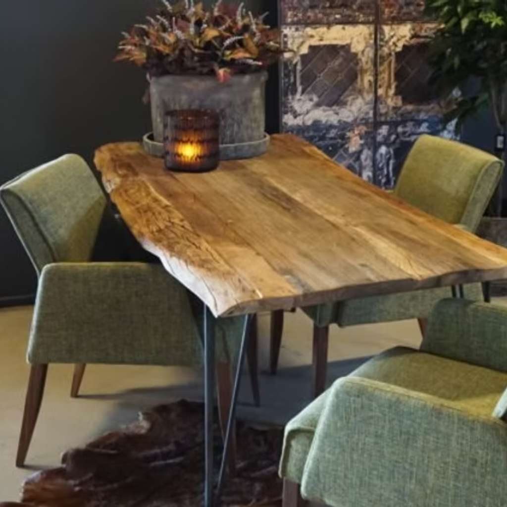 Nou natural wood dining table paired with green chairs for a cozy look.