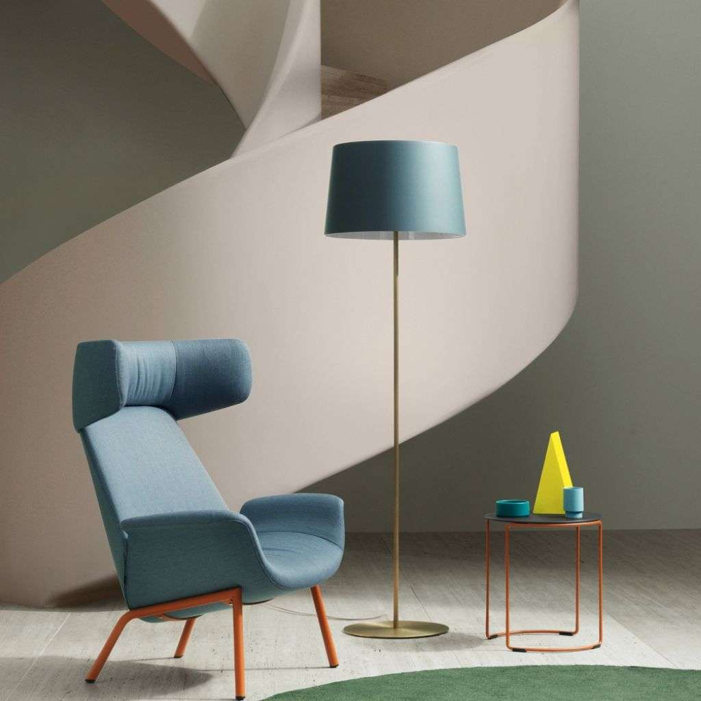 Pedrali modern lounge chair with vibrant floor lamp and geometric decor.