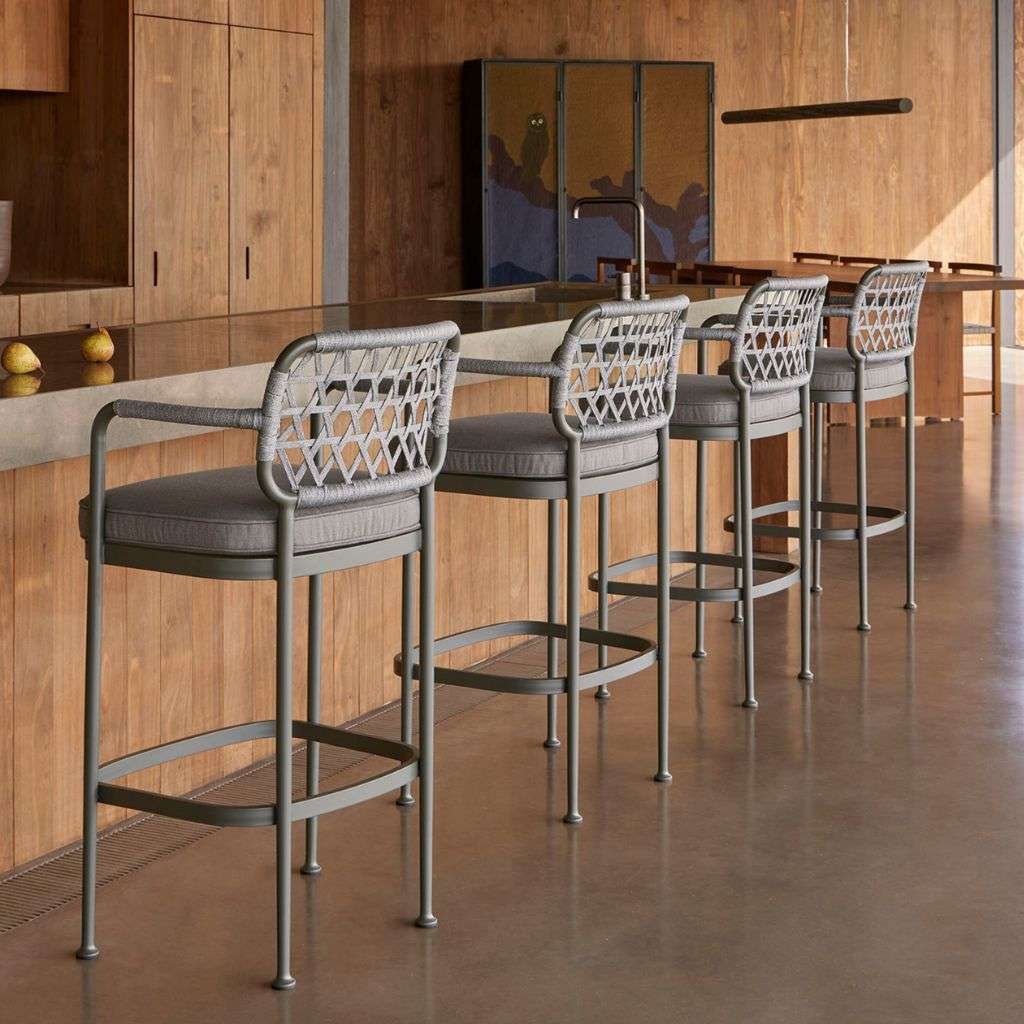 Point bar stools with woven seats and backrests in a sleek kitchen setting