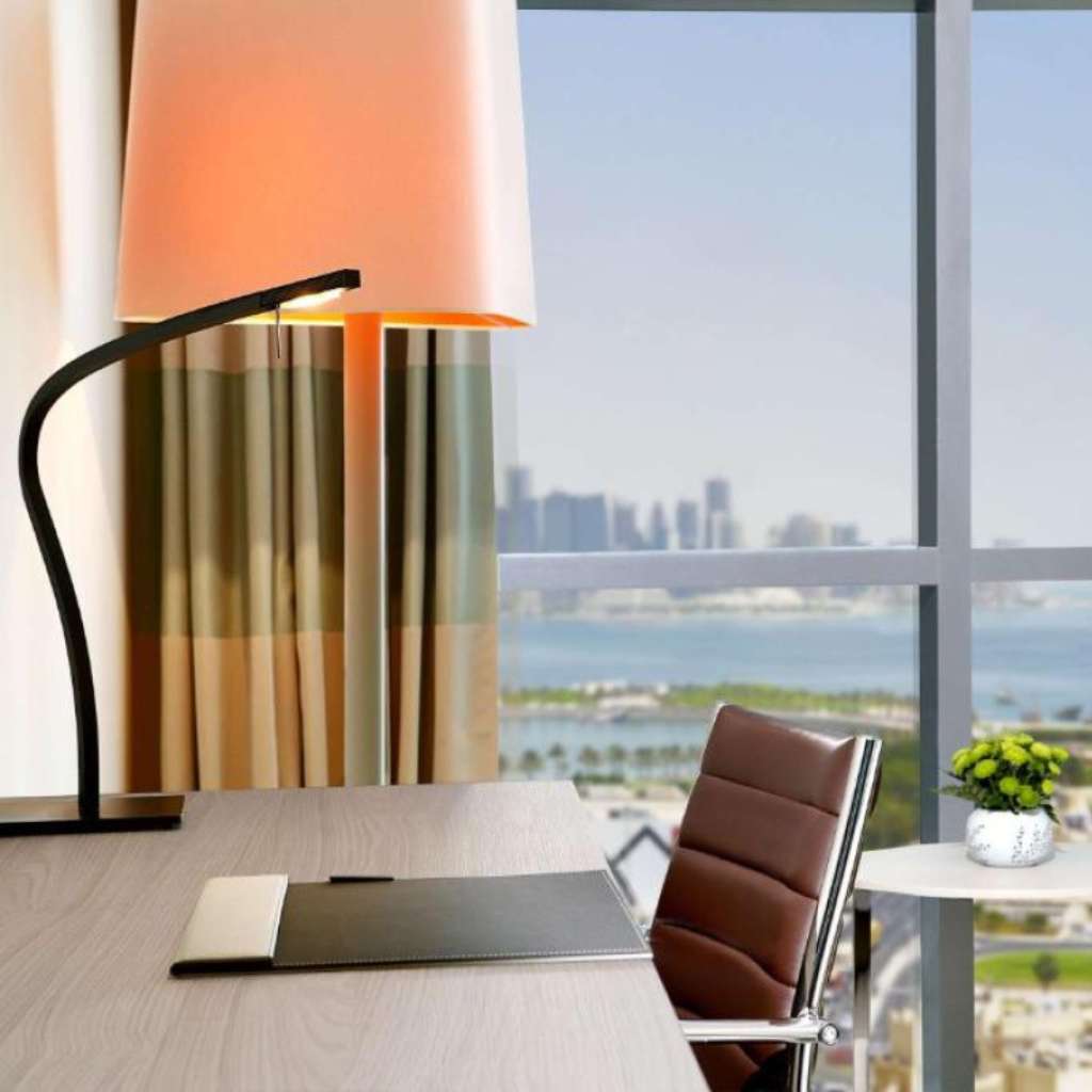 Prandina luxury office lighting with sleek desk lamp and stunning city view.