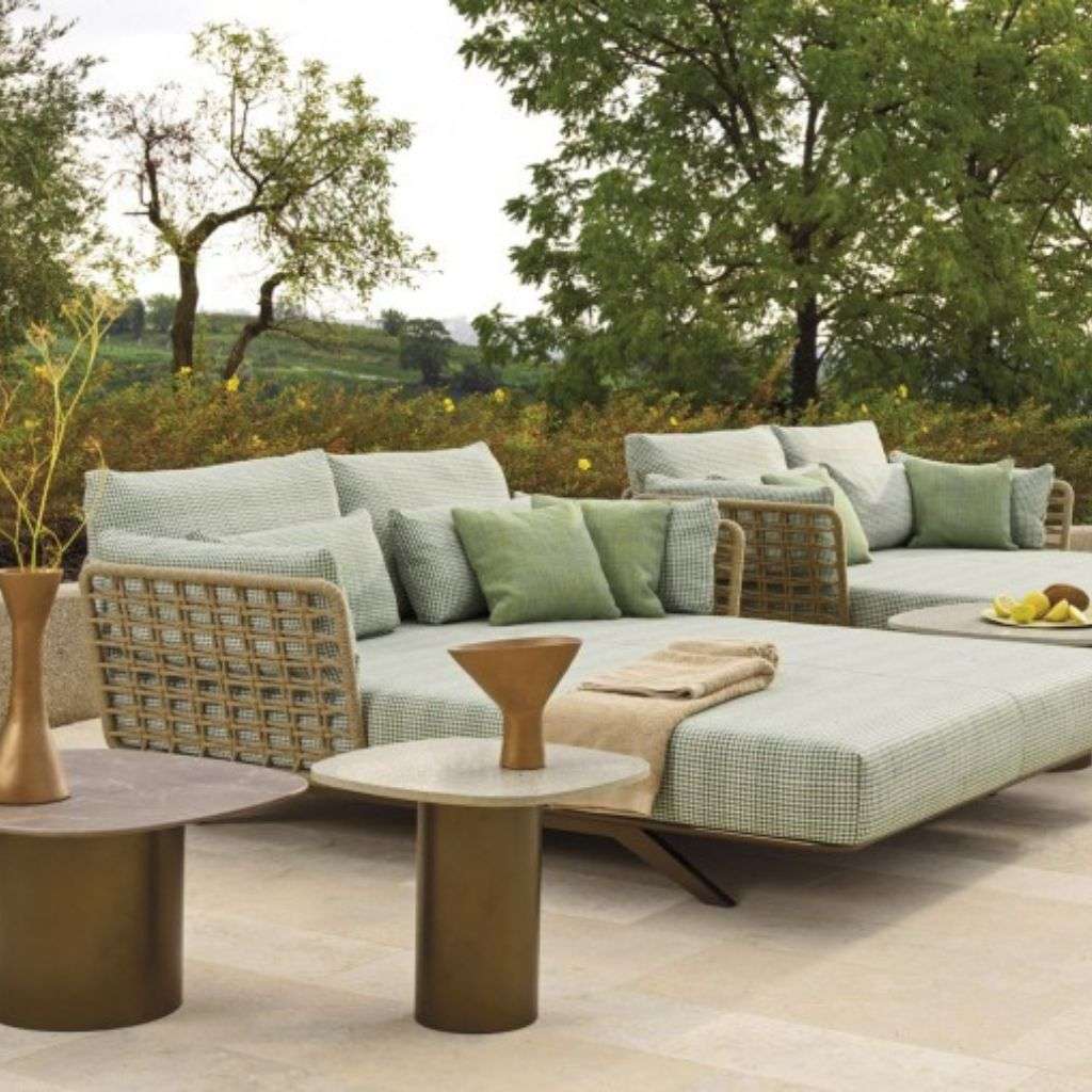 Roberti Rattan lounge with neutral cushions and sleek metal tables for outdoor living.