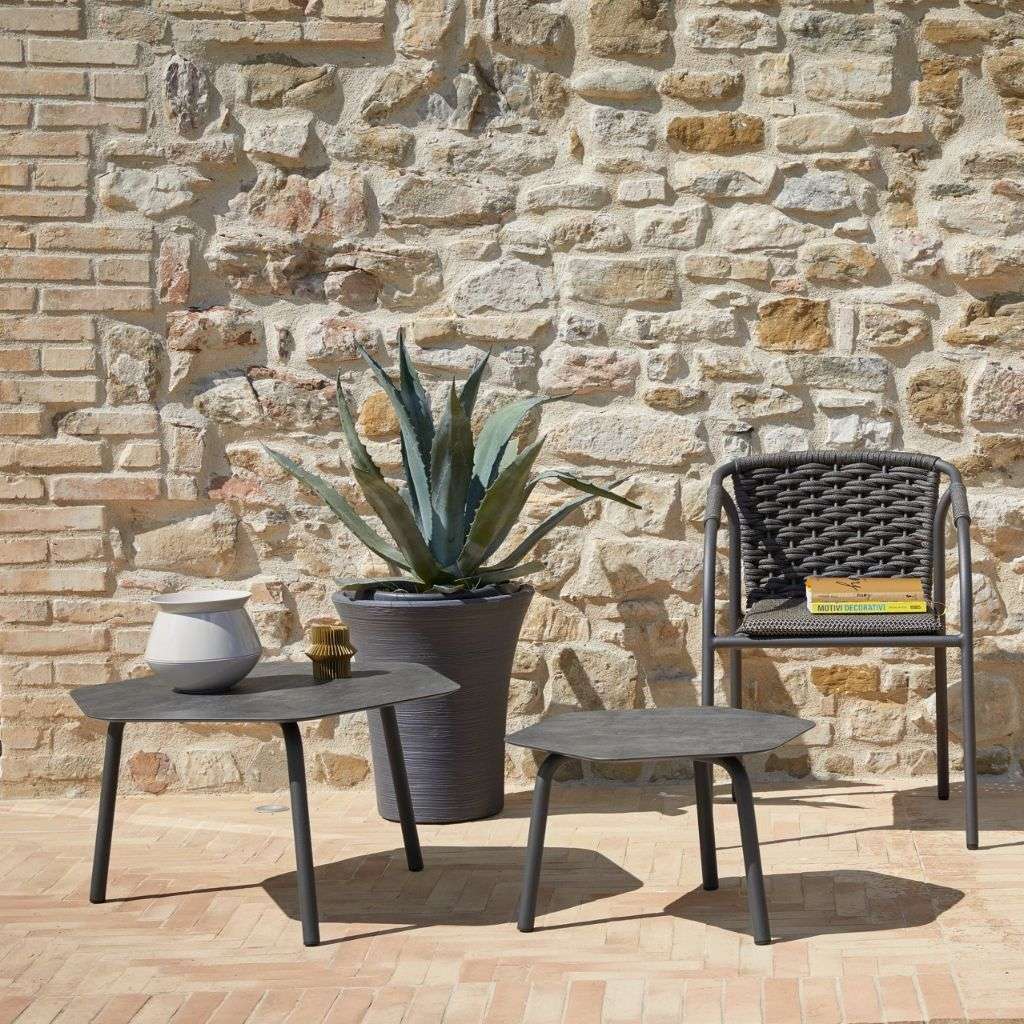 Roberti Rattan seating with vibrant accents and modern rug in a spacious living room.