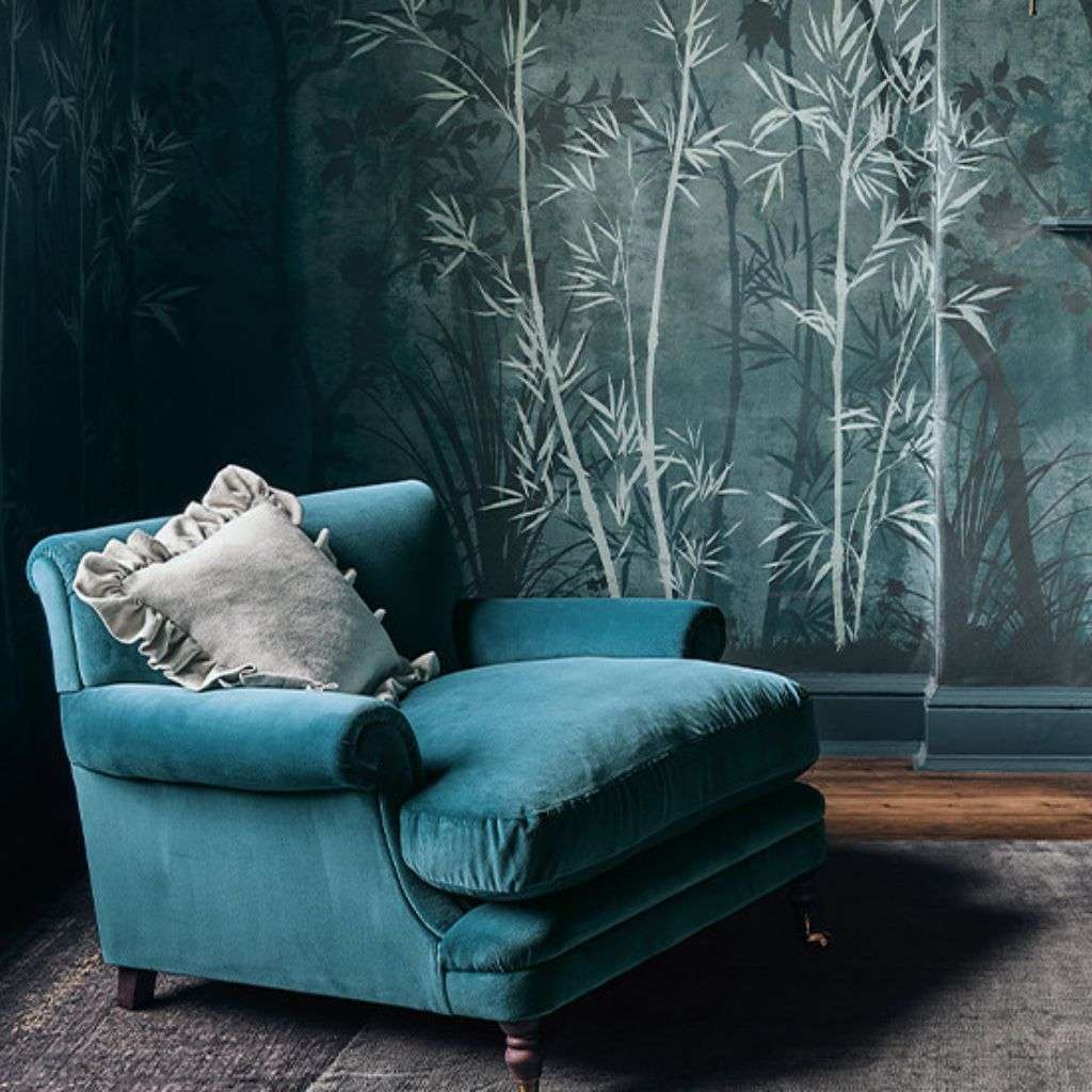 Romo velvet armchair against botanical wallpaper creates a luxurious ambiance.