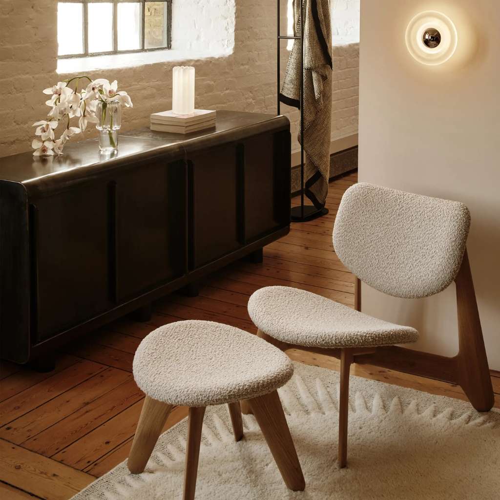 Tom Dixon chair with matching footstool, offering modern design and ultimate comfort.