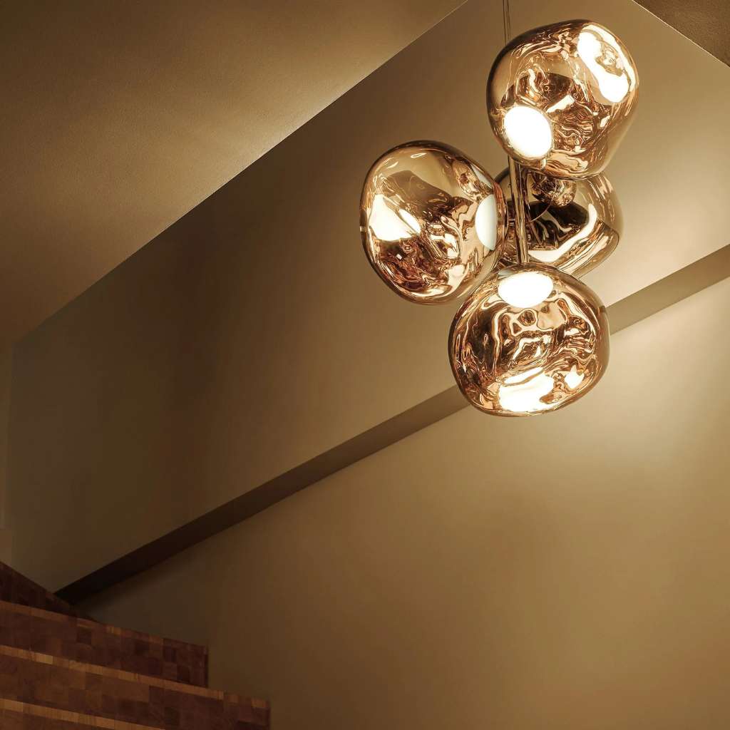 Elegant Melt Mini Chandelier by Tom Dixon illuminating a stairwell.