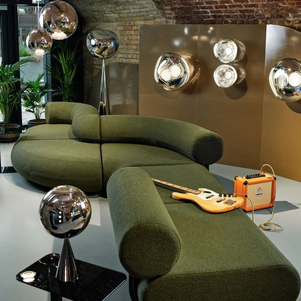 Soft white sofa with ambient lighting in a Tom Dixon-designed living room.