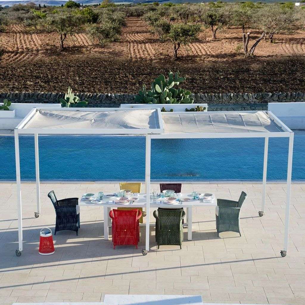 Colorful outdoor dining set with shade by Unopiu.